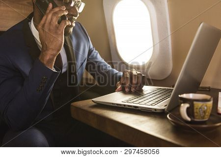 Young Attractive And Successful African American Businessman With Glassies Talking On The Phone And 