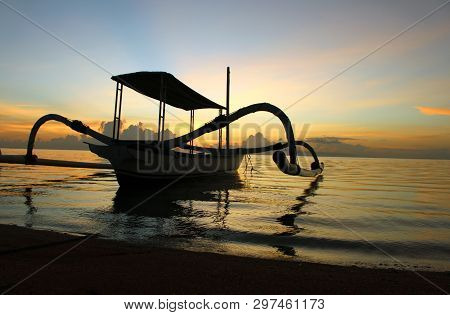 Fishing Boat At Sanur Beach Early Morning View With Colorful Sunrise Color Background, Bali, Indones