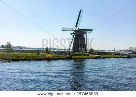 Waterways Of North Holland With Boats And View On Traditional Dutch Mill, Spring Landscape