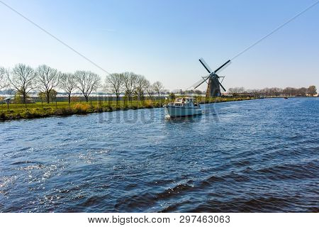 Waterways Of North Holland With Boats And View On Traditional Dutch Mill, Spring Landscape