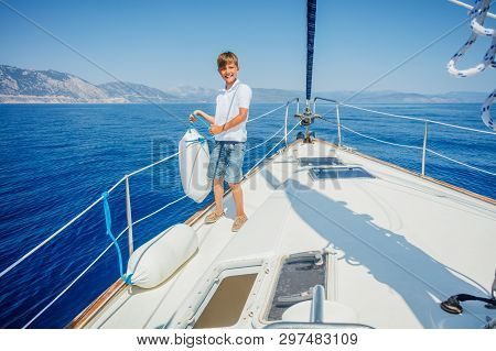 Little Boy On Board Of Sailing Yacht On Summer Cruise. Travel Adventure, Yachting With Child On Fami