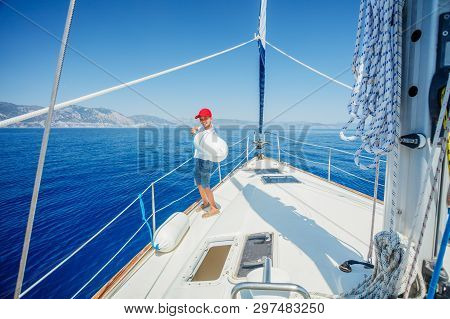 Little Boy On Board Of Sailing Yacht On Summer Cruise. Travel Adventure, Yachting With Child On Fami