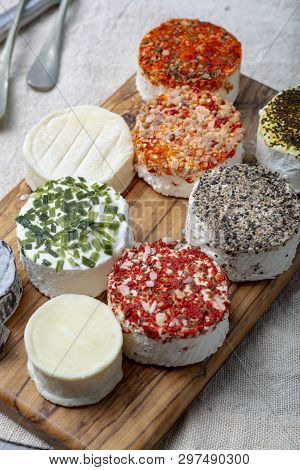 Assortment Of French Fresh White Soft Goat Cheeses With Different Tastes Topping Made With Herbs, Pa