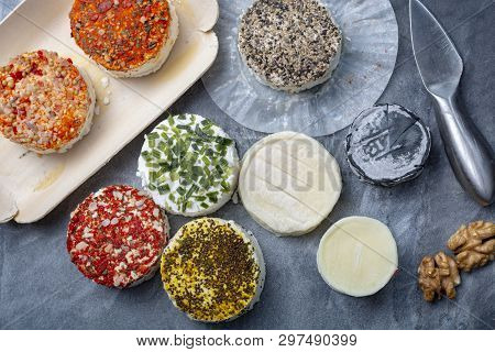 Assortment Of French Fresh White Soft Goat Cheeses With Different Tastes Topping Made With Herbs, Pa