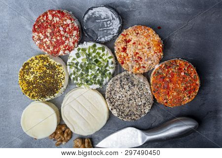 Assortment Of French Fresh White Soft Goat Cheeses With Different Tastes Topping Made With Herbs, Pa