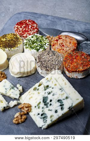 Assortment Of French Fresh White Soft Goat Cheeses With Different Tastes Topping Made With Herbs, Pa