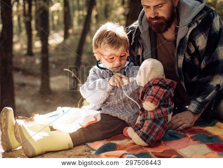Father And Child Son In Autumn Park Having Fun And Laughing. Happy Family, Father And Baby Son Playi