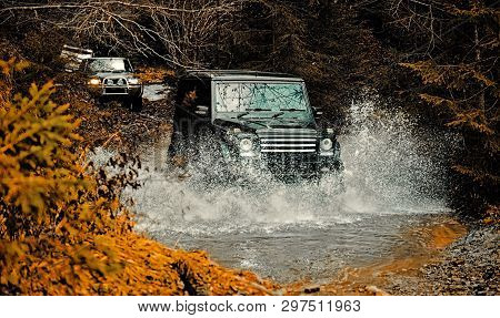 Mud And Water Splash In Off-road Racing. Off Road Sport Truck Between Mountains Landscape. Expeditio