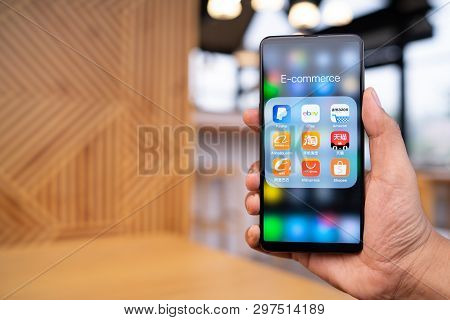 Chiang Mai, Thailand - Mar. 23,2019: Man Holding Xiaomi Mi Mix 3 With Icons Of E-commerce And Online