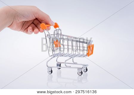 Hand Holding A Cart On A White Background