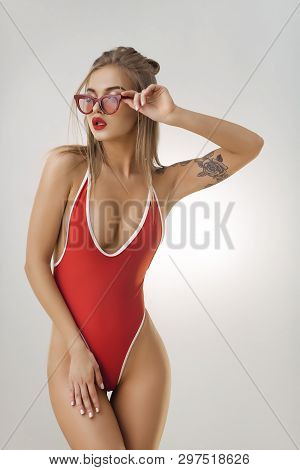 Glamour Beach Woman With Perfect Makeup Wearing Sexy Red Bikini And Retro Sunglasses Isolated On Bri