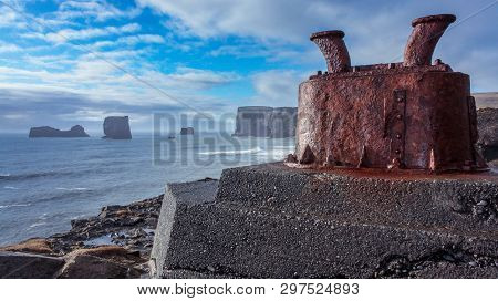 Cliffs Of Vik, Iceland - February 22, 2011: Norays Rusty In The Foreground And Vik Cliffs In The Bac
