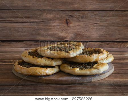 Arabic Meat Sfiha Over A Wooden Table