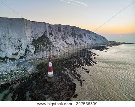 Aerial Drone Landscape Image Of Lighthouse And Chalk Cliffs At Sunrise In England