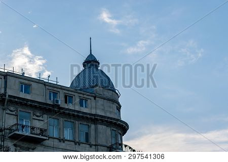 With Houses Made Of Stone Bricks. Daytime Landscape Dome Building Blue Sky. Building Dome At Dusk