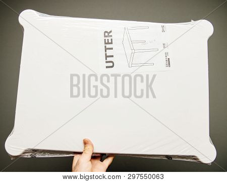 Paris, France - Apr 16, 2019: Man Hand Holding Against Gray Background Ikea Plastic Utter Table