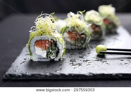 Sushi Roll With Salmon, Cucumber, Cheese, Kampyo And Avocado Slices.