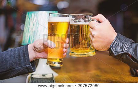 Cheers Concept. Glass With Fresh Lager Draft Beer With Foam. Male Hands Hold Mugs Filled With Cold T