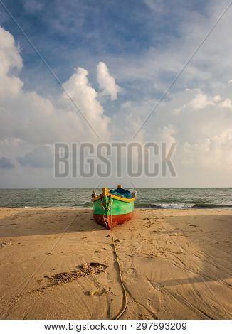 Fishing Boat On The Yellow Sandy Beach With Clouds And Blue Sky At Dhanushkodi Rameswaram India.