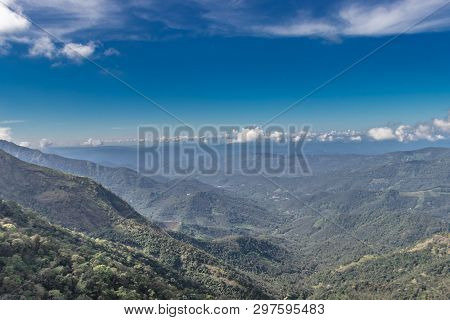 Hill Layers With Shadow, Blue Sky And Forests.