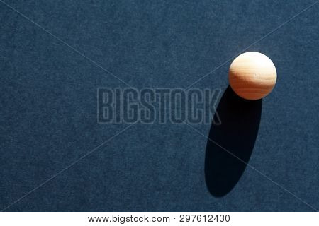Abstract Composition With Three Small Wooden Balls On Dark Blue Background