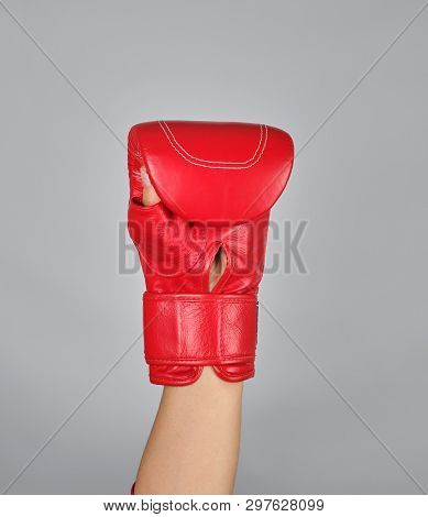 Raised Up Hand In Red Boxing Glove On Gray Background