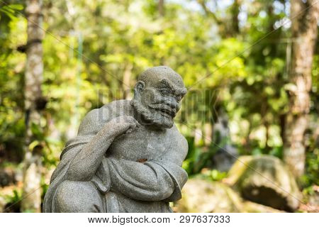 stone ruined Arhat statue in forest, Taiwan, Asia