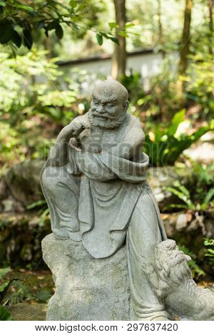 stone ruined Arhat statue in forest, Taiwan, Asia