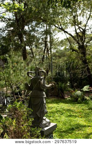 stone ruined Arhat statue in forest, Taiwan, Asia