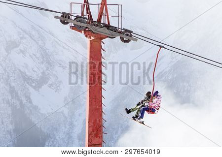 Dombai, Russia - January 3, 2014: People Are Lifting On Open Lft High Up In Caucasus Mountains