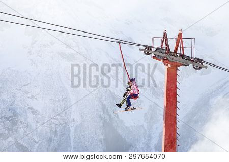 Dombai, Russia - January 3, 2014: People Are Lifting On Open Lft High Up In Caucasus Mountains
