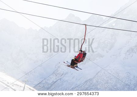 Dombai, Russia - January 3, 2014: People Are Lifting On Open Lft High Up In Caucasus Mountains