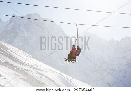 Dombai, Russia - January 3, 2014: People Are Lifting On Open Lft High Up In Caucasus Mountains
