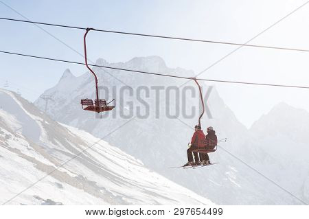 Dombai, Russia - January 3, 2014: People Are Lifting On Open Lft High Up In Caucasus Mountains