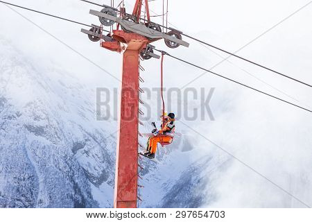Dombai, Russia - January 3, 2014: People Are Lifting On Open Lft High Up In Caucasus Mountains