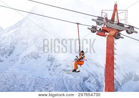 Dombai, Russia - January 3, 2014: People Are Lifting On Open Lft High Up In Caucasus Mountains