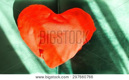 Heart Shaped Small Decorative Pillow On Soft Green Pouffe. Modern Interior Cozy Design Element