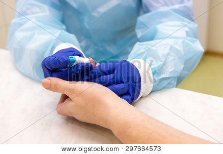 Blood test in the laboratory. Finger blood scarification. 
blood test for viruses