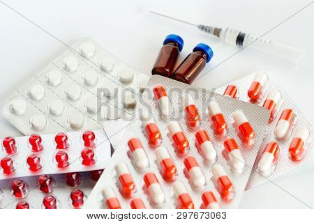 Pills, Capsules, Vitamins, Syringe And Ampoules On A White Background