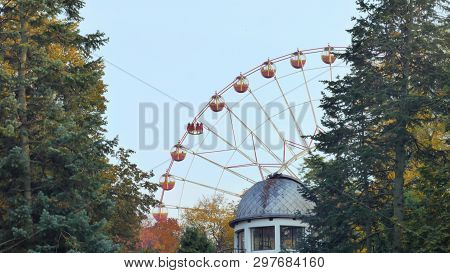 Ferris Wheel Rotates In A Park In The Foreground Roof Observatory