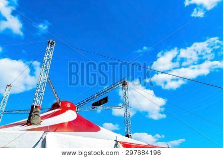 Circus Tent Top. Red And White Stripes. Blue Sky And White Clouds Above