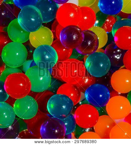 Close Up Of Small Jelly Like Beads In Many Colors Making A Bright Colorful Background Foe Signs, Car