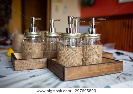 Set Of Glass Bottles With Pump Dispenser On A Tray