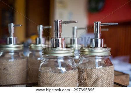 Set Of Glass Bottles With Pump Dispenser On A Tray