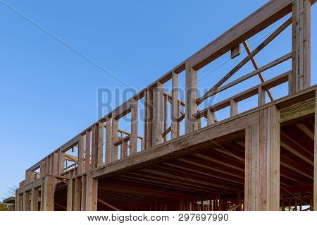 New Construction Of Beam Construction House Framed The Ground Up Framing Against A Blue Sky