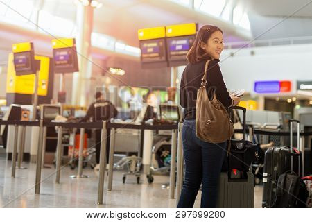 Happy Woman With Smile Hand Holding Passport And Boarding Pass.