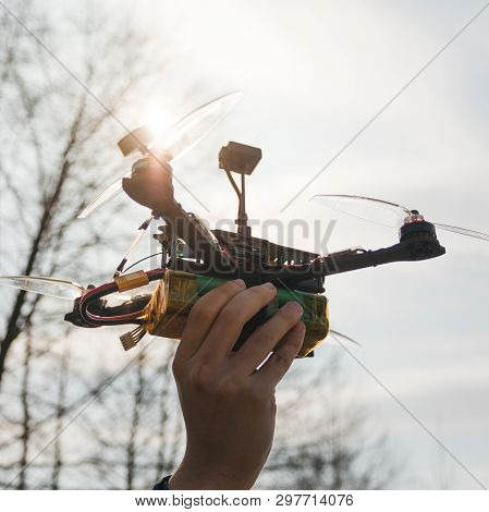 Pilot Racing Drone Holds In His Hand Fpv Copter Before Launching It. A Small High-speed Aircraft Wit