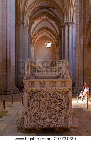 Alcobaca, Portugal - July 17, 2017: Gothic Tomb of King Dom Pedro with recumbent effigy. Monastery of Santa Maria de Alcobaca Abbey. Funerary art Masterpiece. 