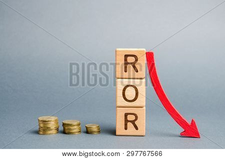 Wooden Blocks With The Word Ror And Arrow Down. Financial Ratio Illustrating The Level Of Business L