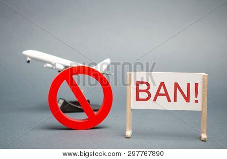 A Poster With The Word Ban. The Sign Of The Ban And A Miniature Toy Aircraft. Ban On Flights Of Civi